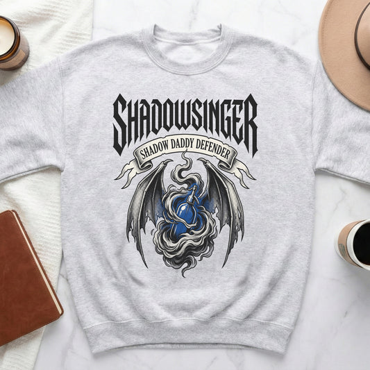 Grey sweatshirt with "Shadowsinger Shadow Daddy Defender" text and dragon wings design.