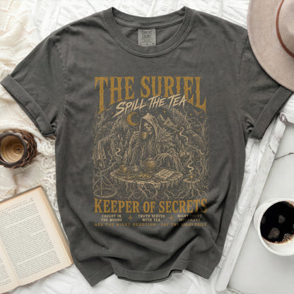 Dark grey t-shirt with "The Suriel Spill the Tea" and grim reaper design.