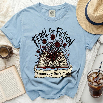 Light blue t-shirt with "Feral for Fiction Romantasy Book Club" graphic.