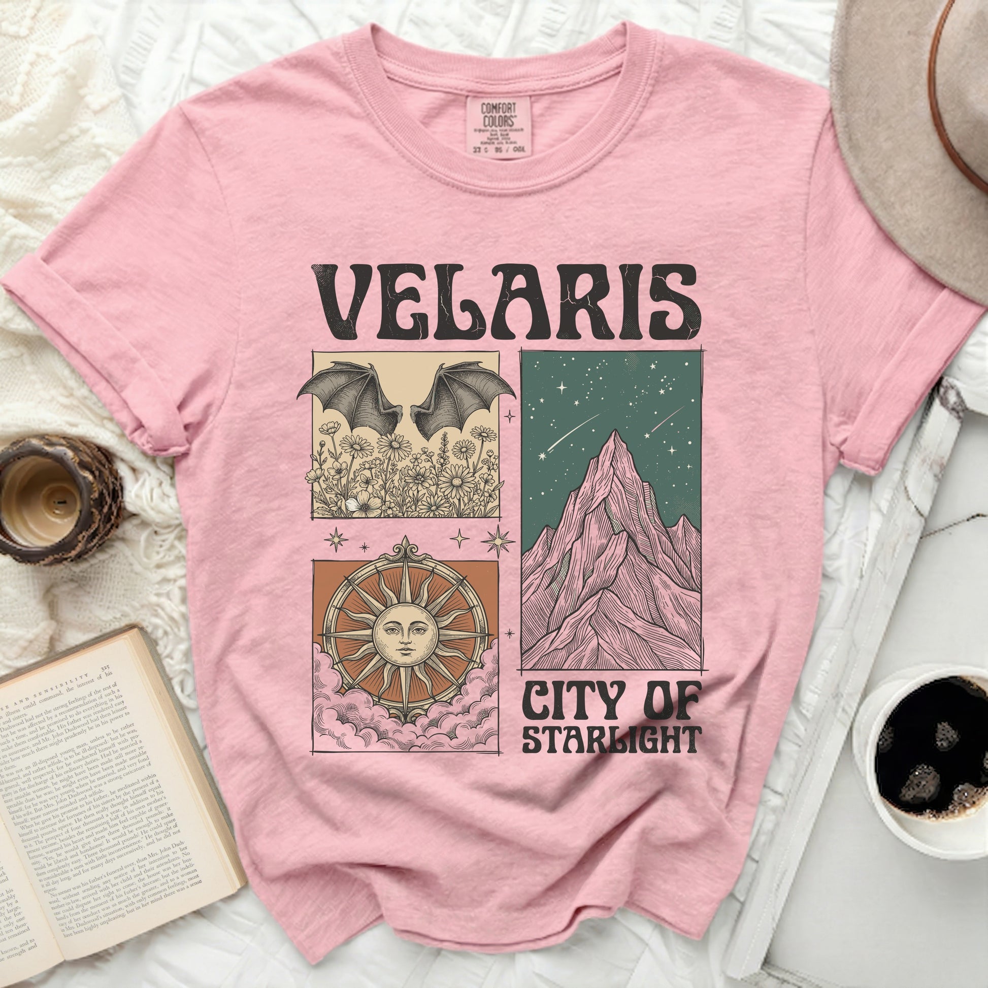 Pink t-shirt with "Velaris City of Starlight" text and square graphic designs.