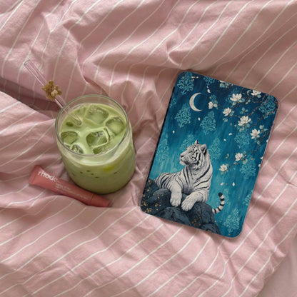 White tiger art on blue background, with drink and lip balm on pink fabric.
