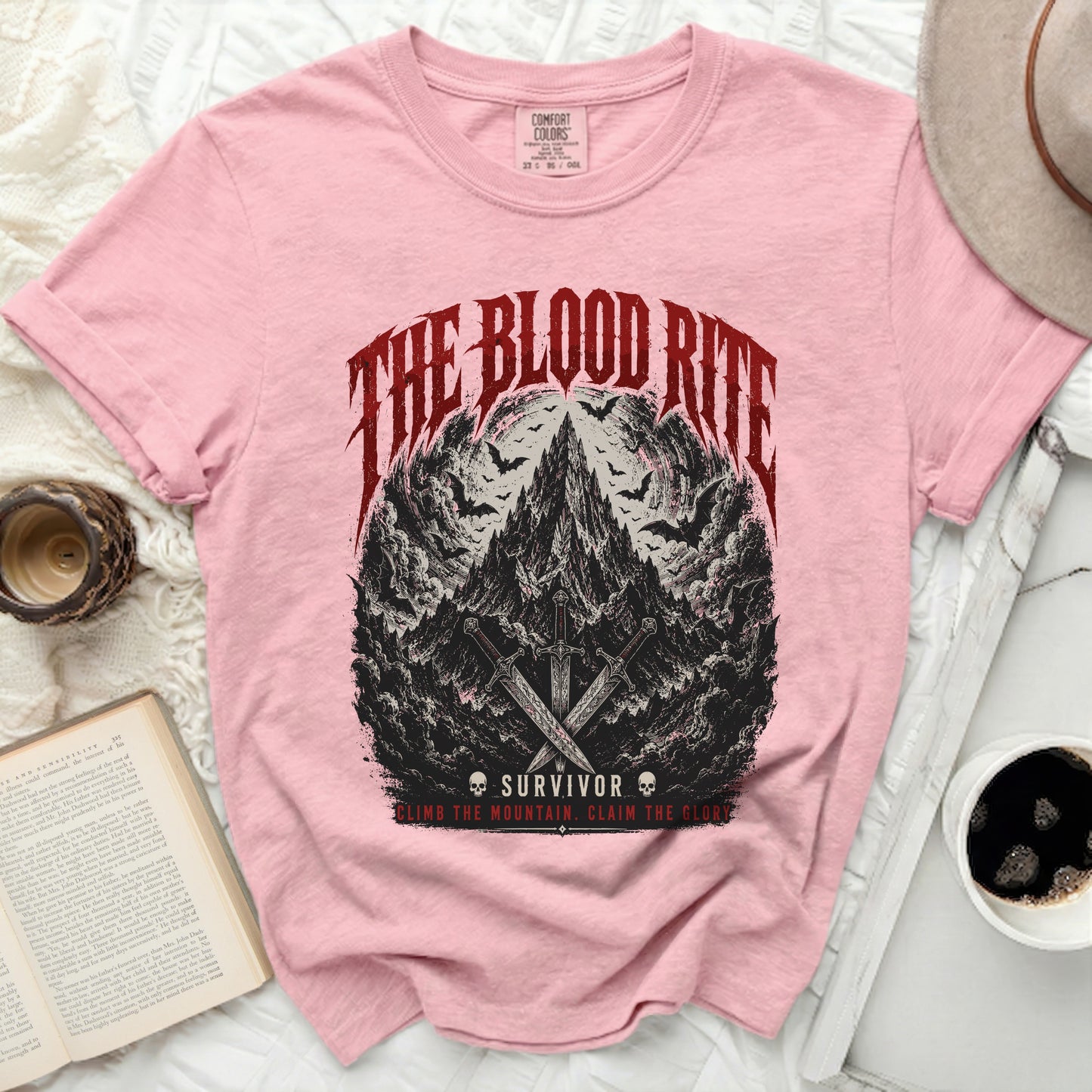Pink t-shirt with "The Blood Rite Survivor" graphic and swords.