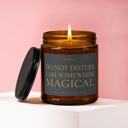 Amber candle with a lit wick and lid resting beside it, text reads "DO NOT DISTURB. I AM SOMEWHERE MAGICAL."