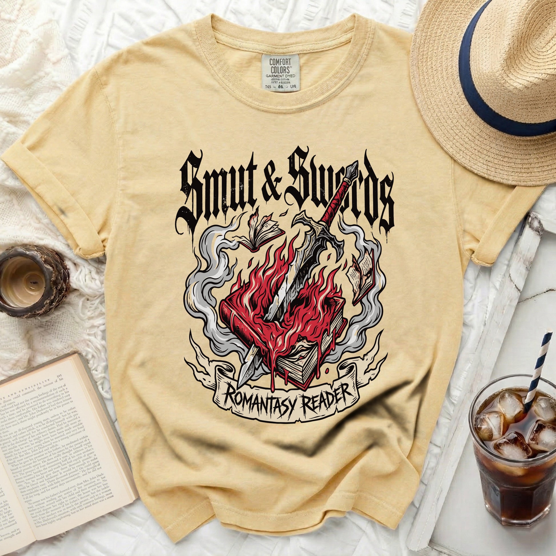 Yellow t-shirt with "Smut & Swords Romantasy Reader" graphic.