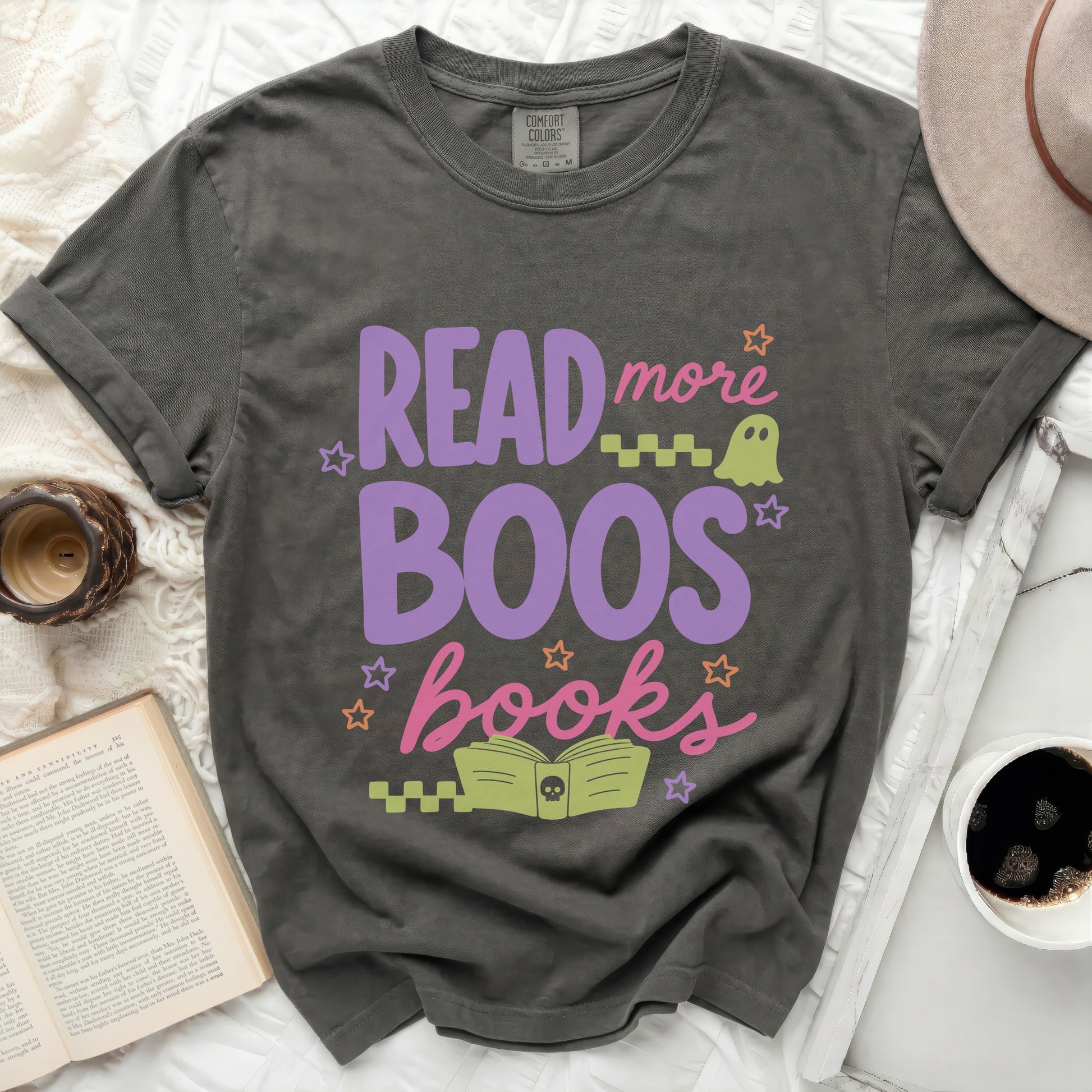 Graphic tee with "Read more Boos books" in purple and pink lettering.