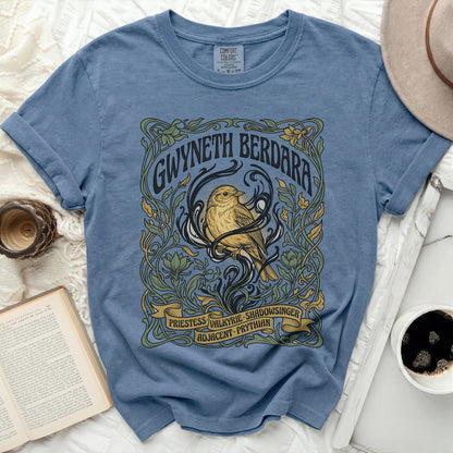 Blue t-shirt with art nouveau design featuring a bird and text.