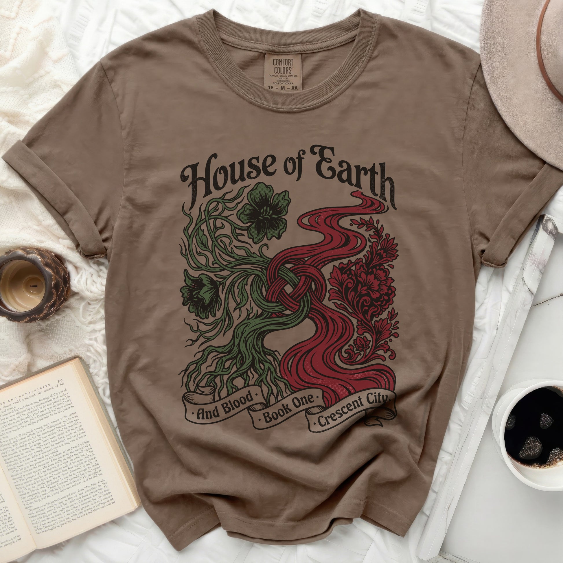 Brown t-shirt with "House of Earth and Blood Book One Crescent City" graphic.