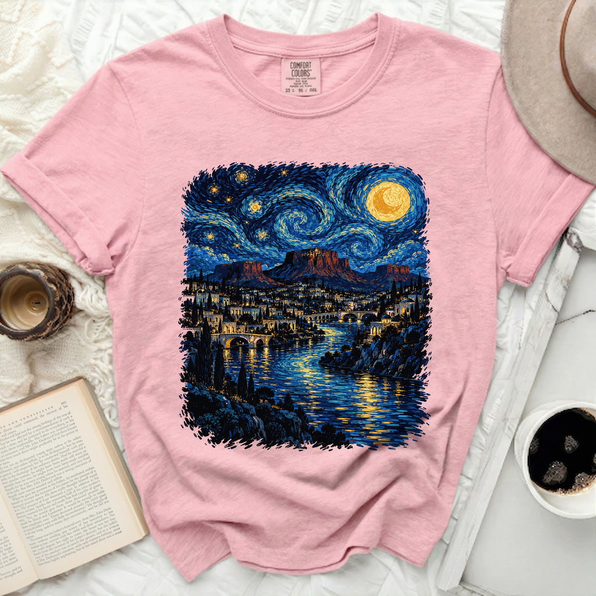 Pink t-shirt with a starry night desert landscape print.