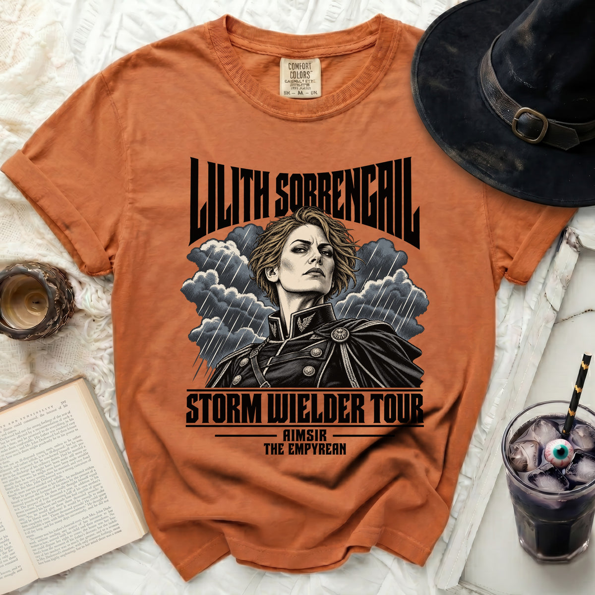 Orange t-shirt with "Lilith Sorrengail Storm Wielder Tour" graphic.