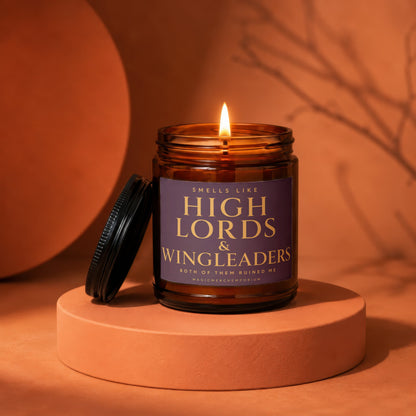 Burning candle in amber jar with "Smells Like High Lords & Wingleaders" label.