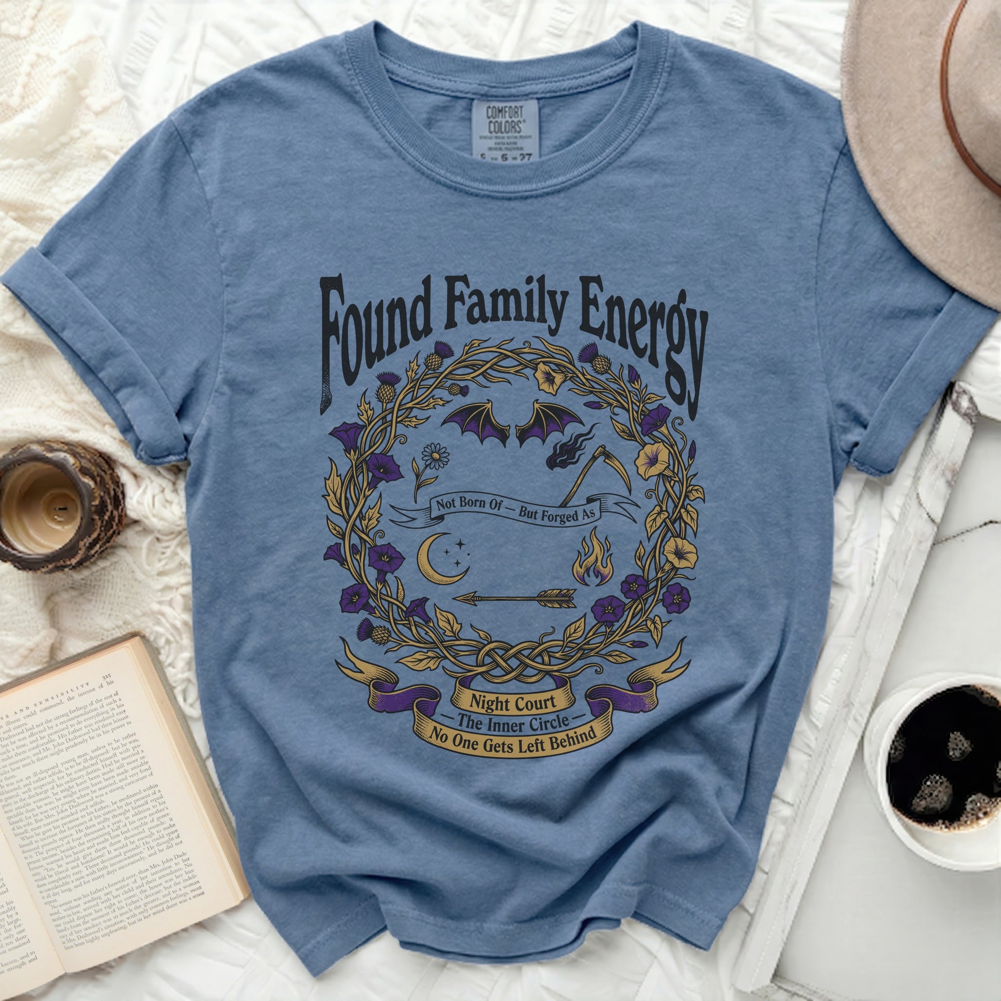 Blue t-shirt with "Found Family Energy" and a circular design.