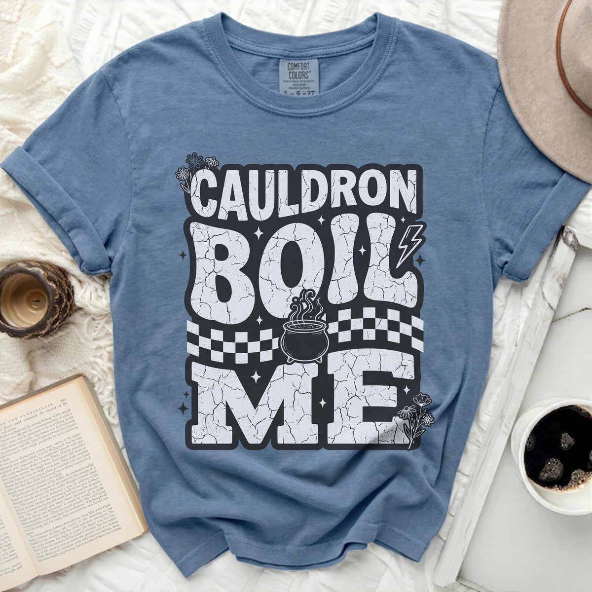 Blue t-shirt with "Cauldron Boil Me" text and cauldron graphic.