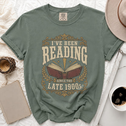 Green t-shirt with "I've Been Reading Since The Late 1900s" graphic.