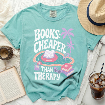 Teal t-shirt with "Books: Cheaper Than Therapy" graphic and pool imagery.