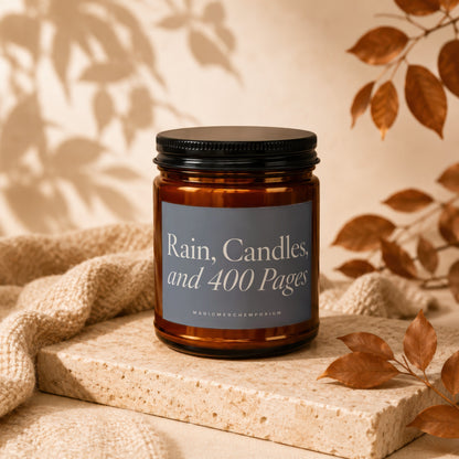 Amber jar candle with label "Rain, Candles, and 400 Pages" on textured block.