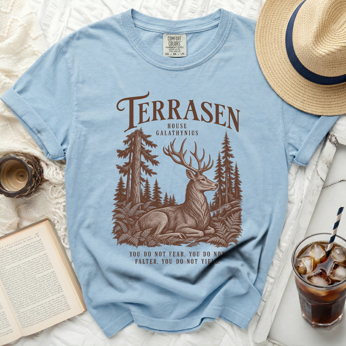 Light blue t-shirt with "Terrasen House Galathynius" and deer design, "You do not fear, you do not falter, you do not yield."