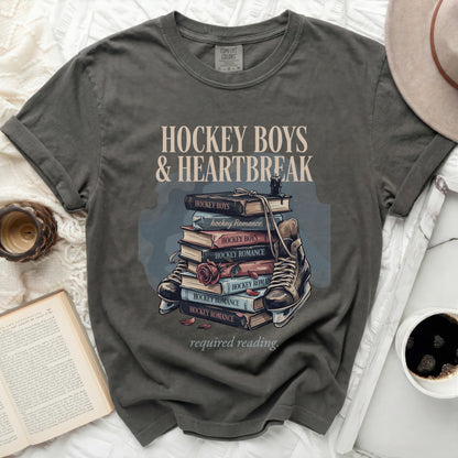 T-shirt graphic featuring books titled "Hockey Boys & Heartbreak" and skates.