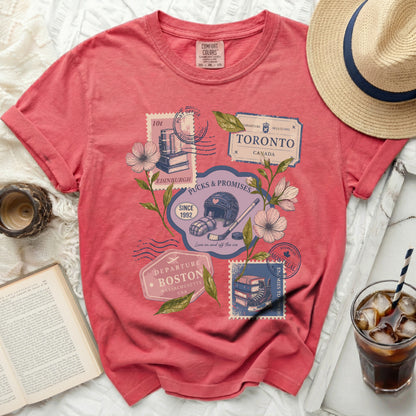 Pink t-shirt with vintage travel stamps: Toronto, Edinburgh, Boston, Quebec.