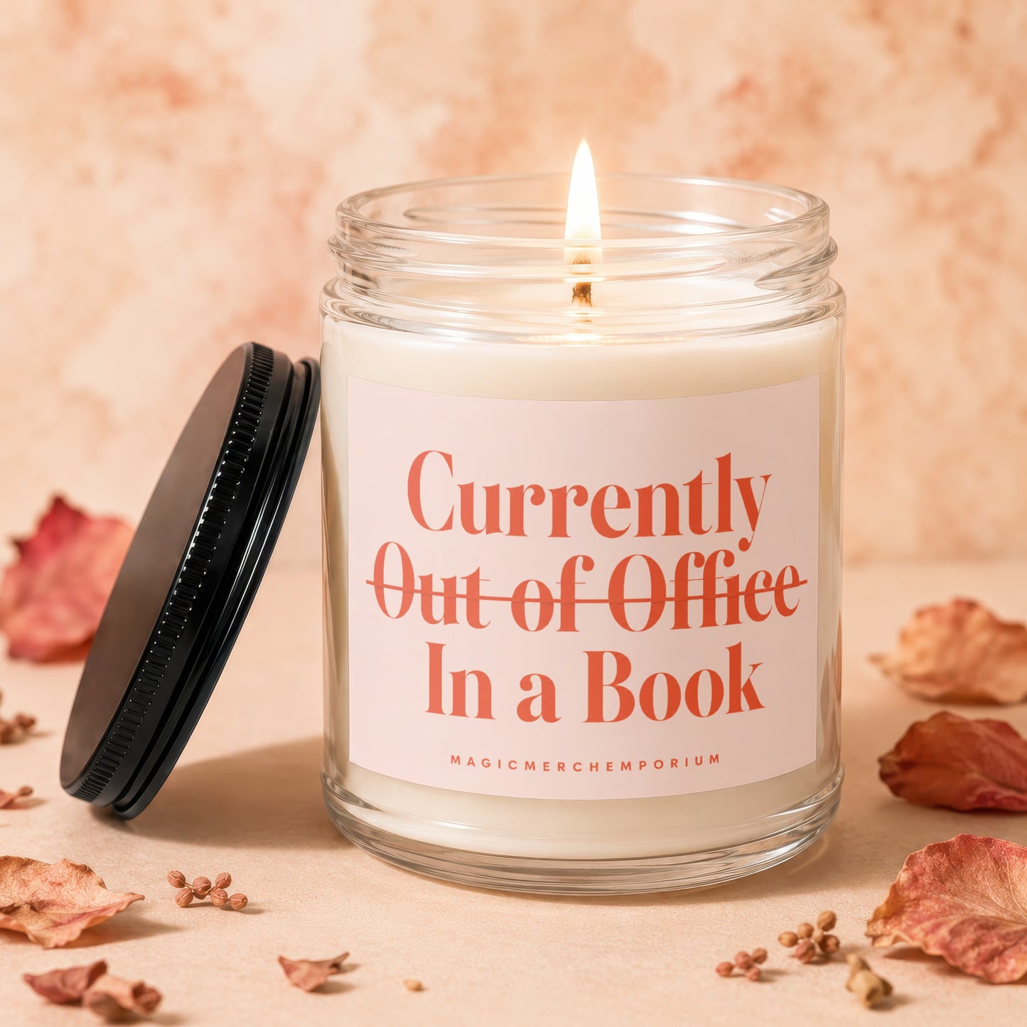 Candle labeled "Currently Out of Office In a Book" with lit wick.