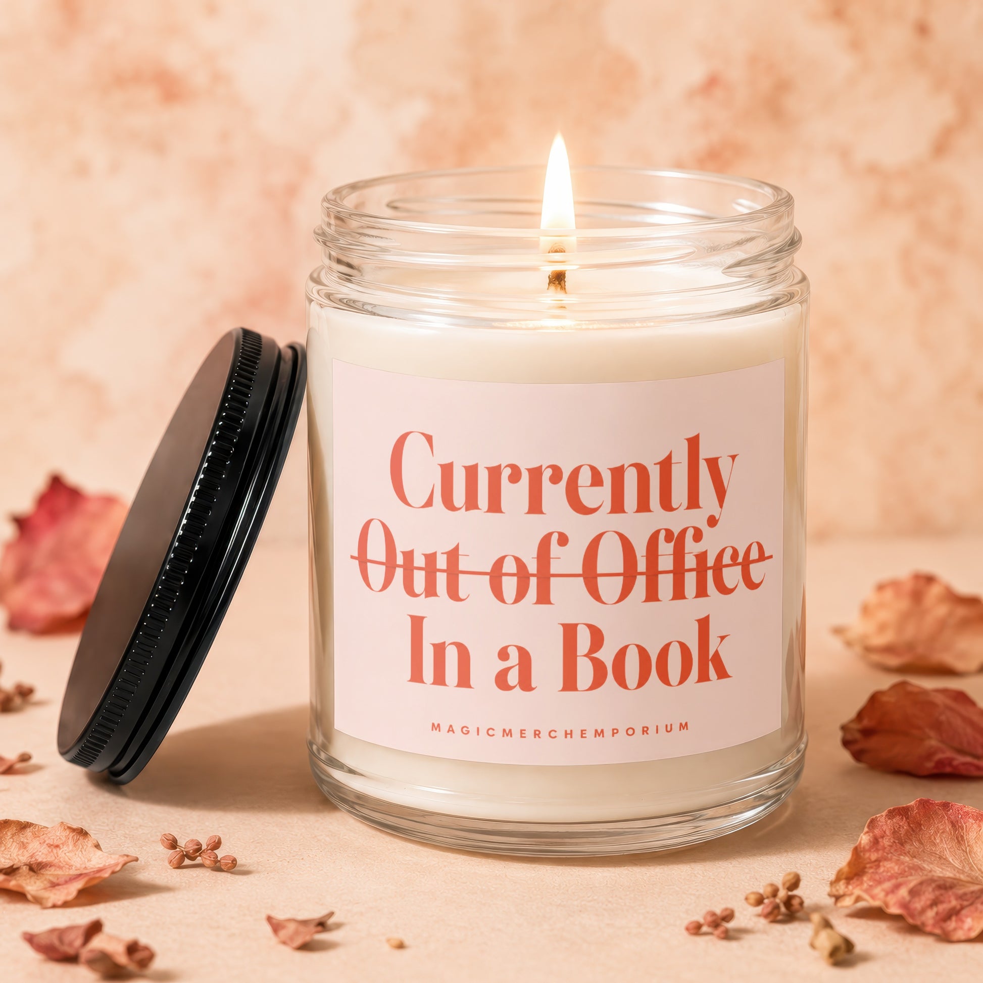 Candle labeled "Currently Out of Office In a Book" with lit wick.
