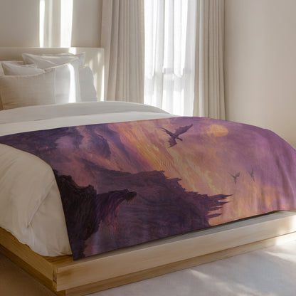 A comforter with a fantasy landscape featuring dragons flying over a castle at sunset.