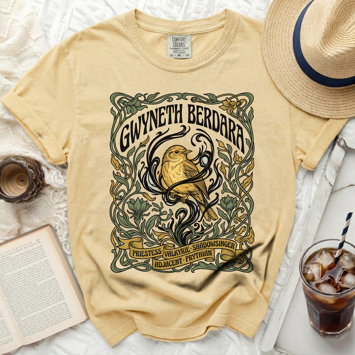 Yellow t-shirt with "Gwyneth Berdara" bird and floral art.