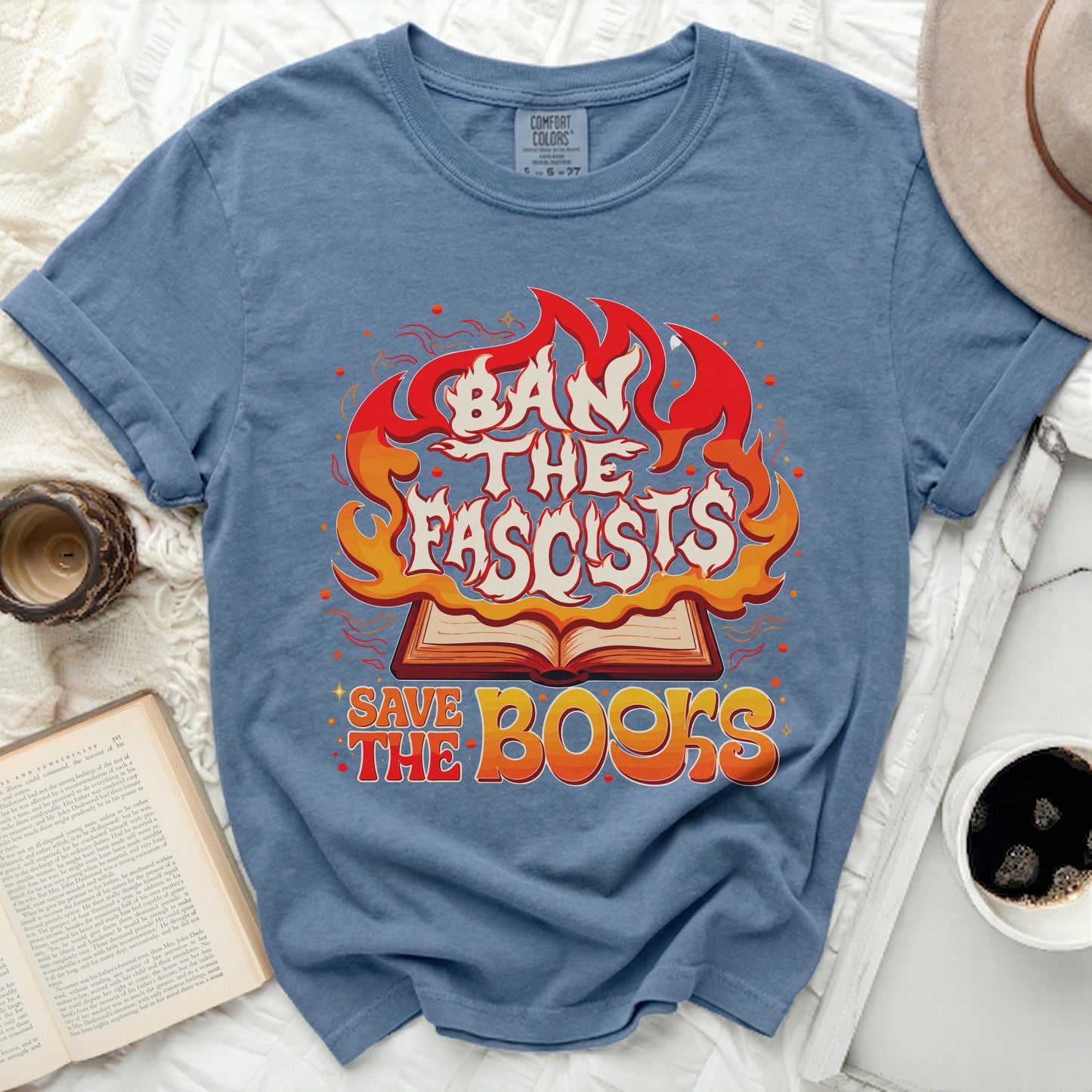 Blue t-shirt with "Ban the Fascists Save the Books" text and flames graphic.
