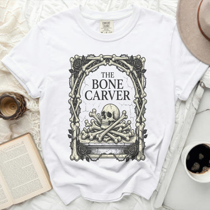 White t-shirt with "The Bone Carver" text and skull graphic.