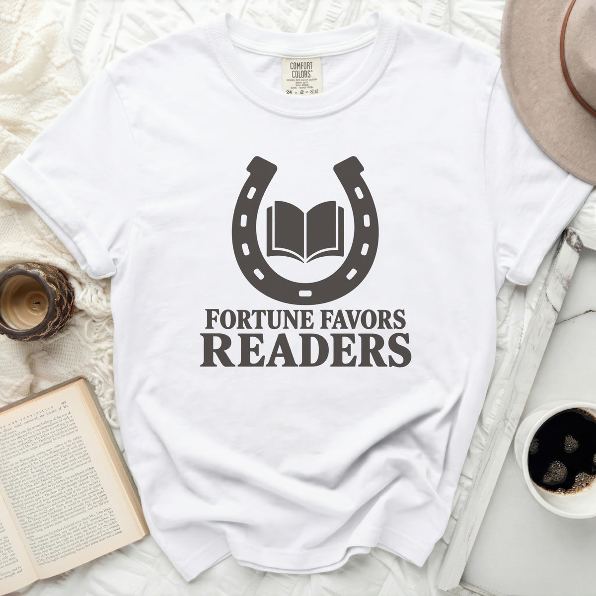 White t-shirt with a dark gray horseshoe and open book graphic.