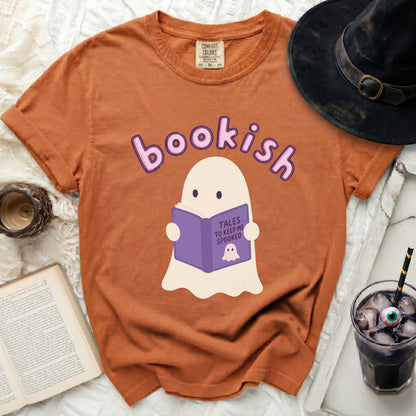 Orange t-shirt with a ghost reading a book that says "Tales to Keep Me Spooked".