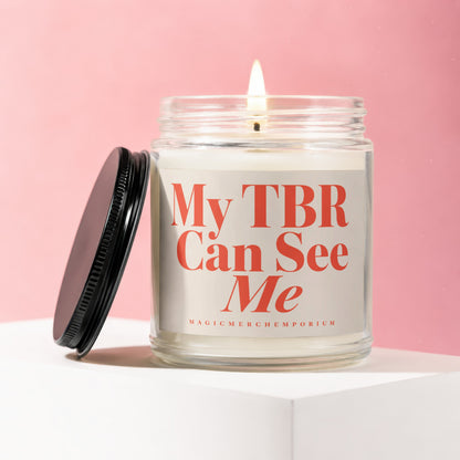Candle with red text "My TBR Can See Me" on a pink background.
