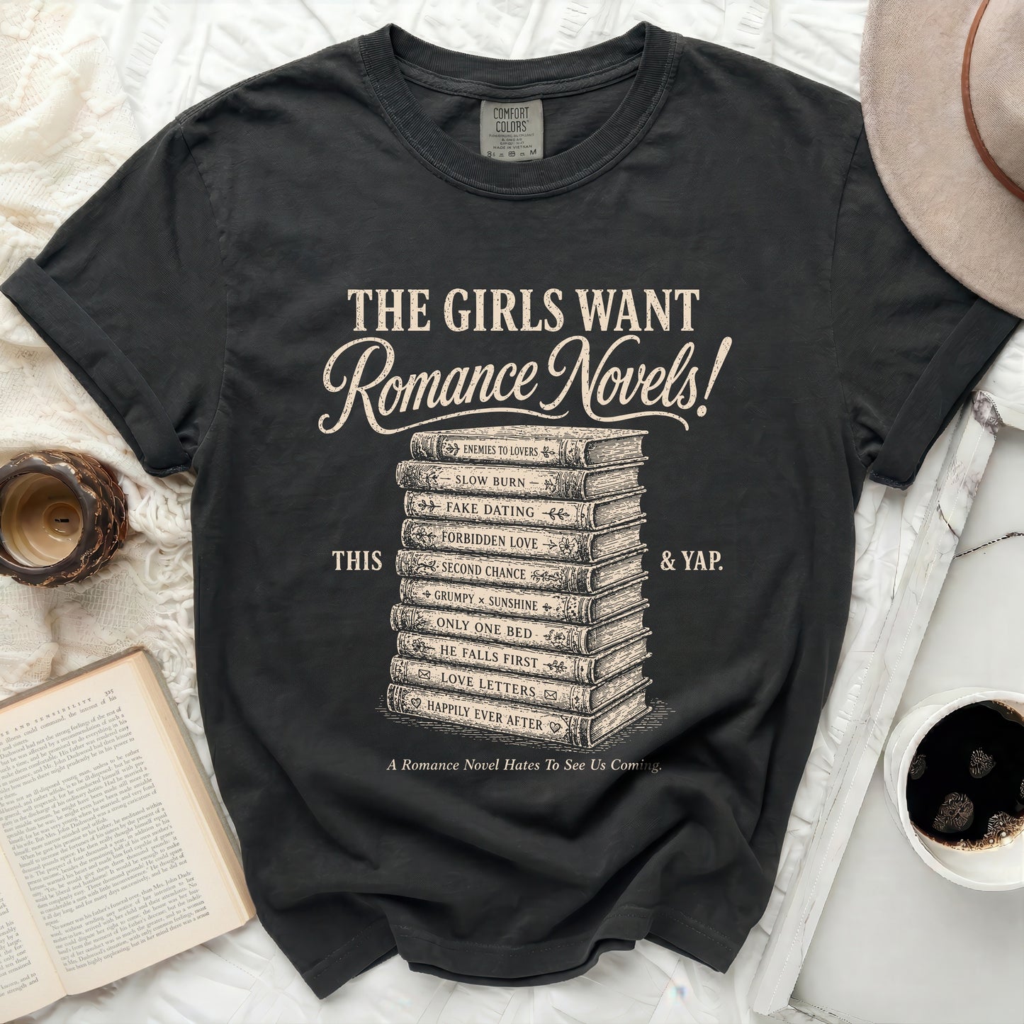 Black t-shirt with stacked romance novel titles and a tagline.
