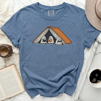 Blue t-shirt with graphic of three reading ghosts inside an open book.