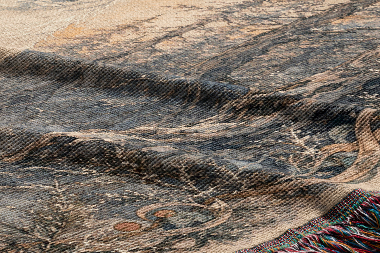 The image is a close-up of a textured fabric with a pattern of trees and foliage, including a tree branch and leaves. The fabric appears to be a woven or knitted material, with a dark and earthy color palette.