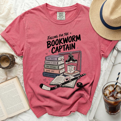 Pink t-shirt with "Falling for the Bookworm Captain" graphic.