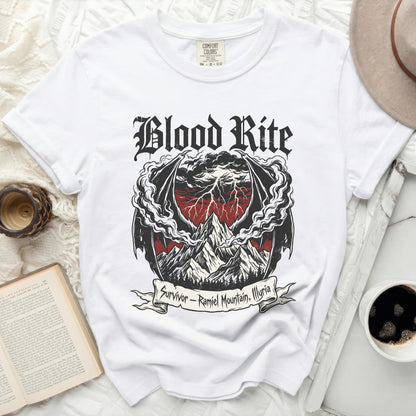 White t-shirt with "Blood Rite" graphic and "Survivor - Ramiel Mountain, Illyria" text.