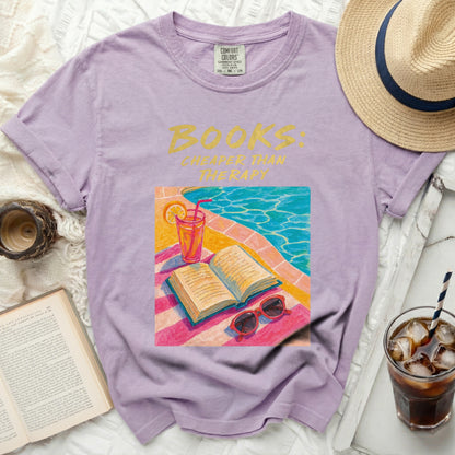 Purple t-shirt with "Books: Cheaper Than Therapy" text and illustration.