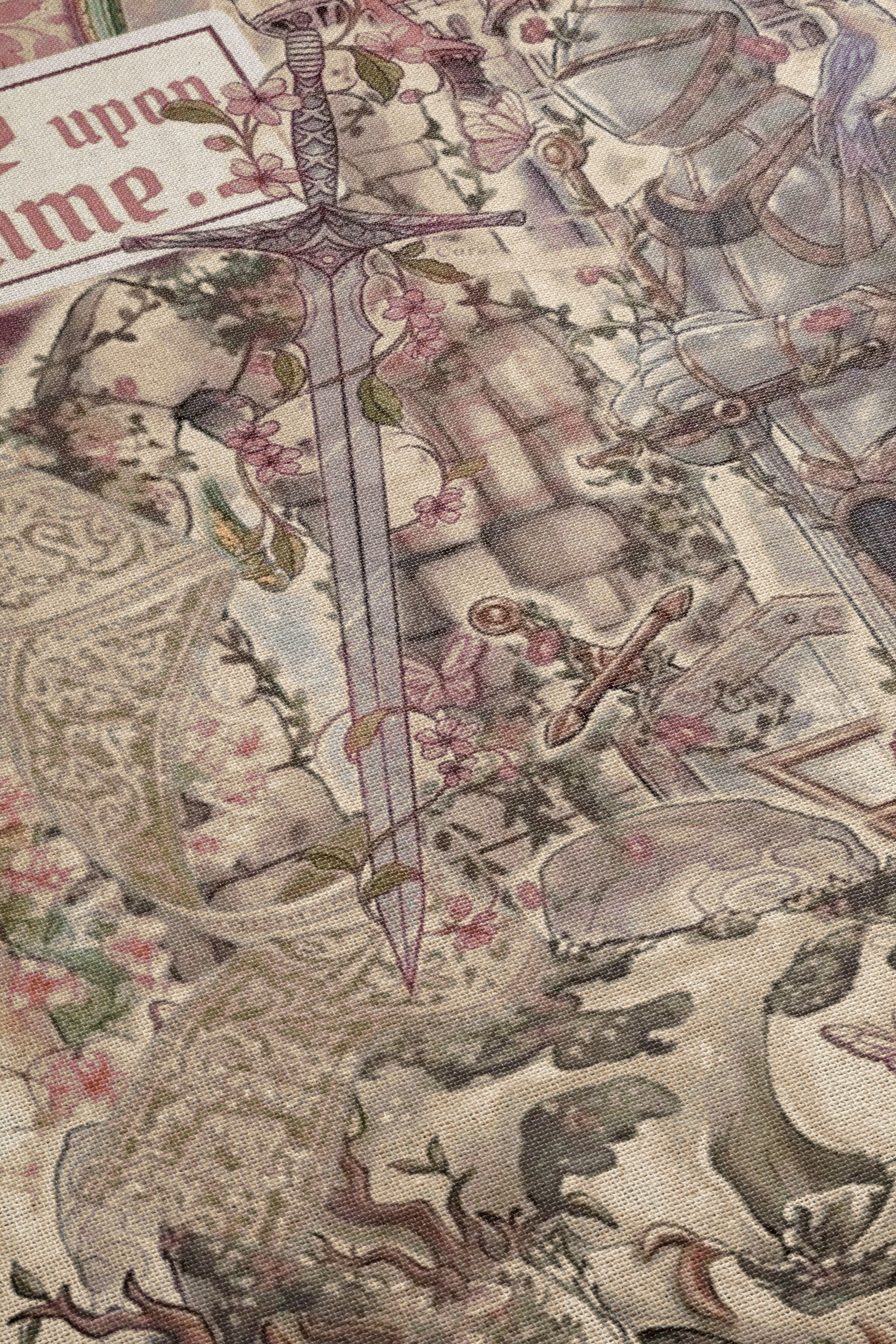 The image is a detailed tapestry or embroidered piece featuring a sword, floral patterns, and other intricate designs.