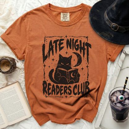 Orange t-shirt with "Late Night Readers Club" graphic of a cat reading.
