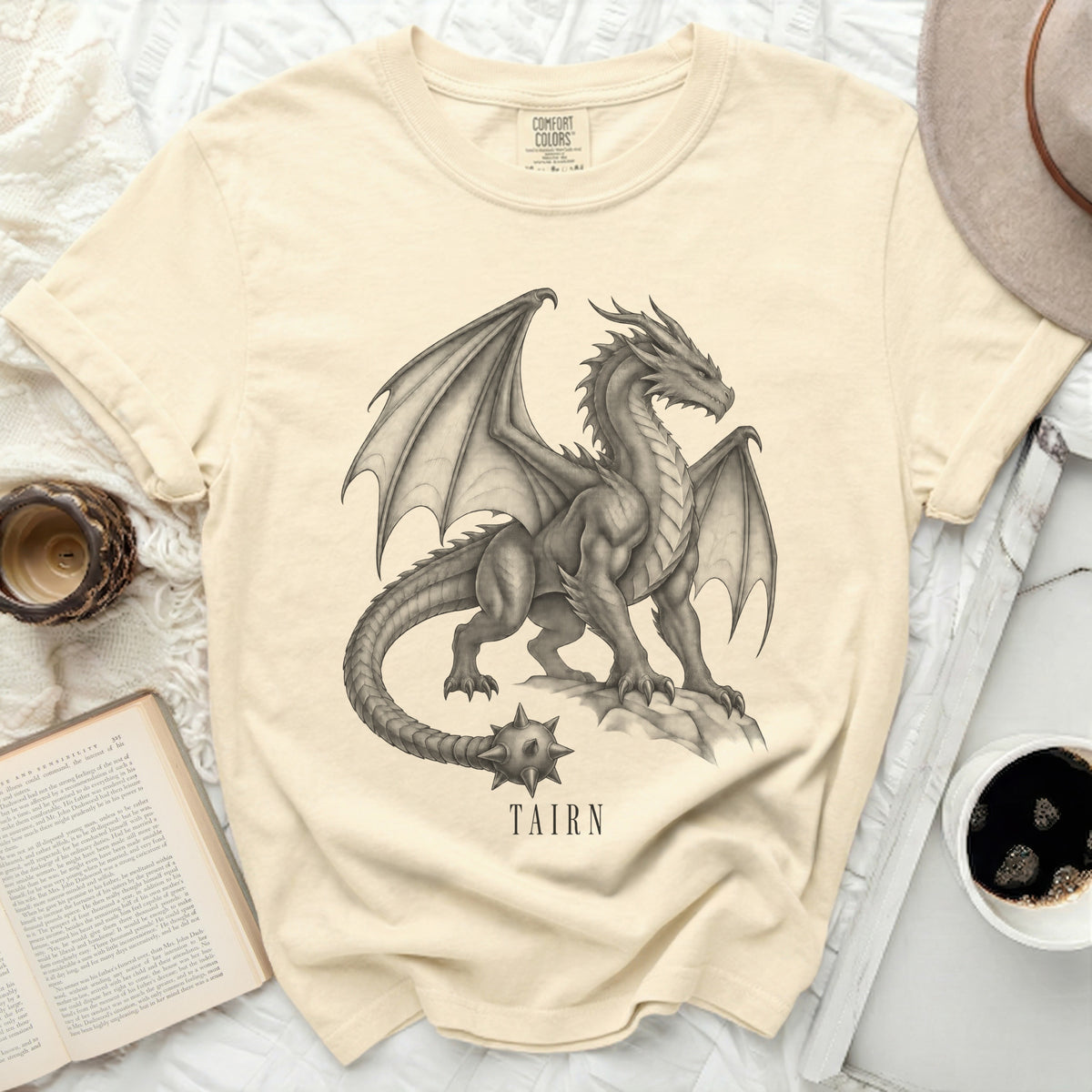Light beige t-shirt with a graphite drawing of a dragon and the word "TAIRN".