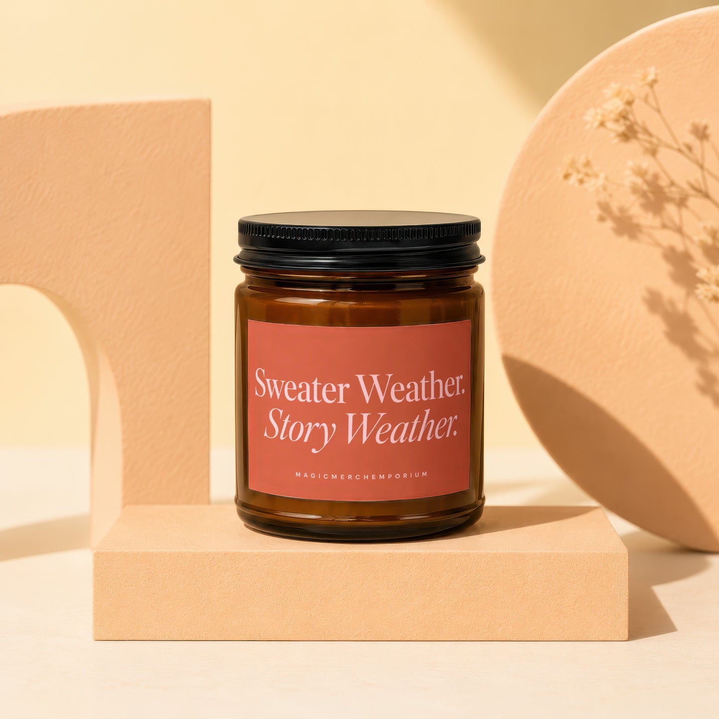 Candle with "Sweater Weather Story Weather" label on a pedestal.