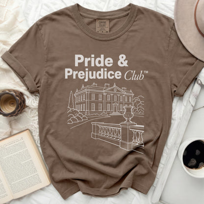 Brown t-shirt with "Pride & Prejudice Club" text and building graphic.