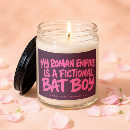 Lit candle in a jar with a purple label that reads "My Roman Empire is a Fictional Bat Boy."