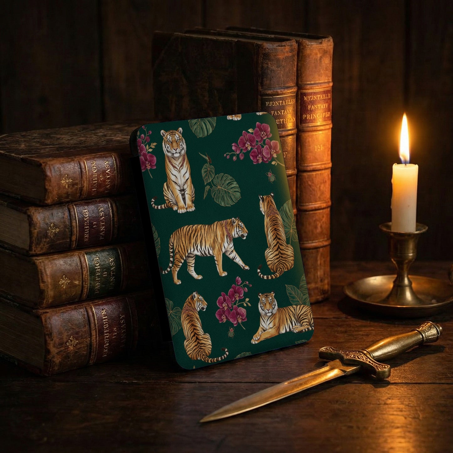 Green cover with tigers and flowers, antique books, and a candle.