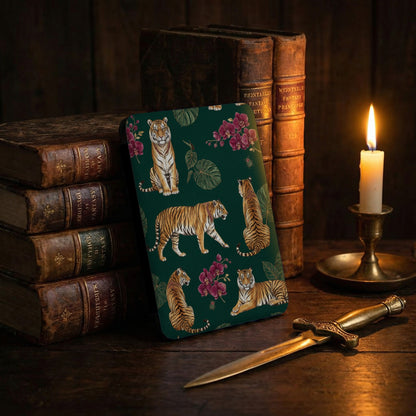 Green cover with tigers and flowers, antique books, and a candle.