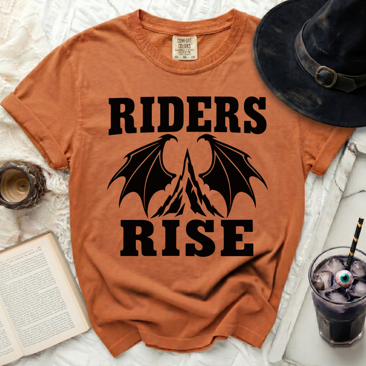 Orange t-shirt with black text "RIDERS RISE" and dragon wings graphic.