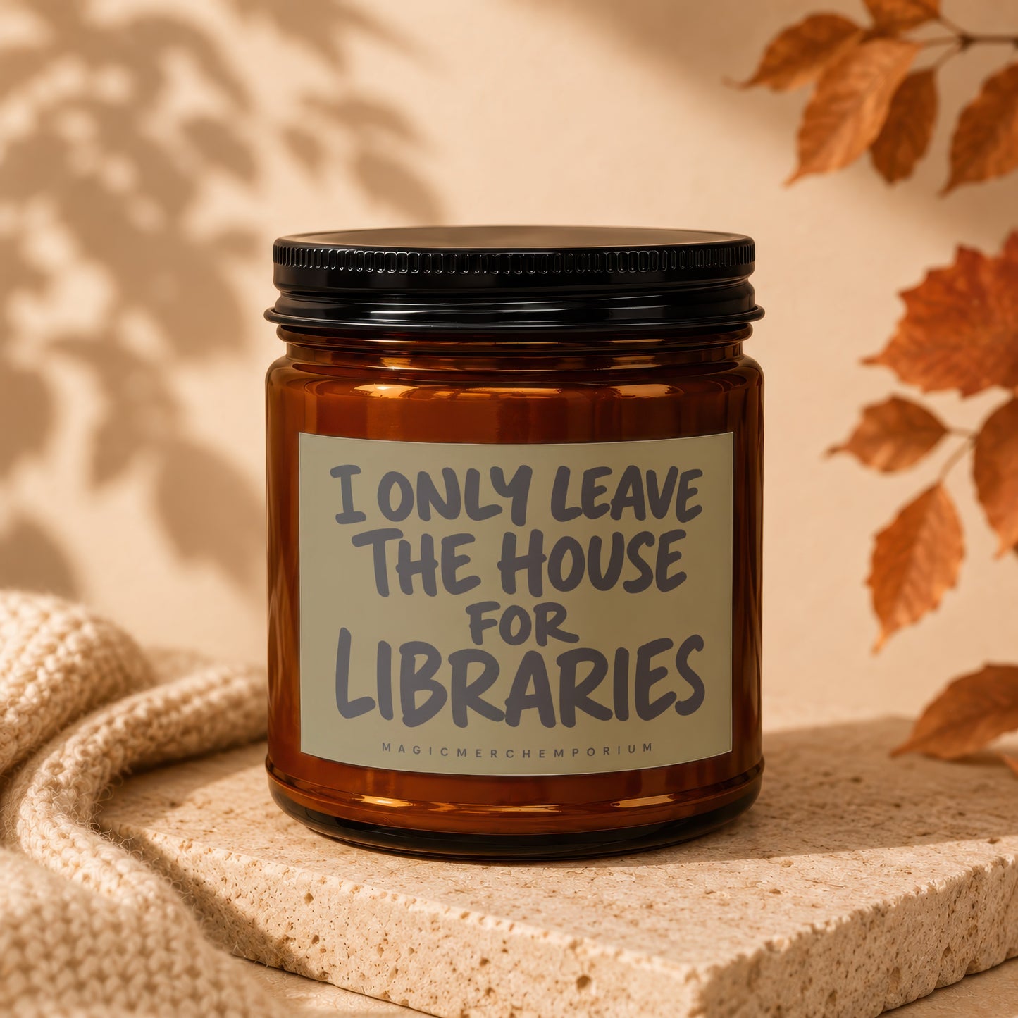 Amber glass candle with label reading "I Only Leave the House for Libraries".