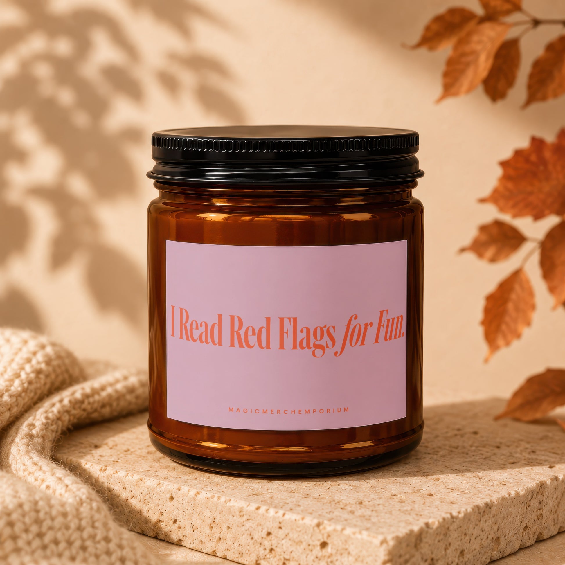 Amber jar candle with pink label saying "I Read Red Flags for Fun."