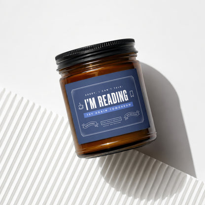 Amber jar candle with "I'M READING" label, soy wax blend.