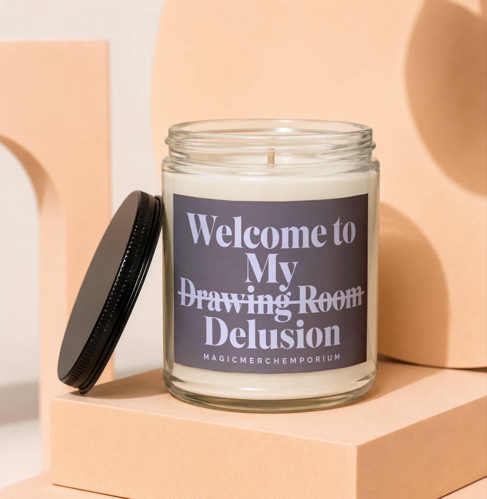 Candle with label saying "Welcome to My Drawing Room Delusion"
